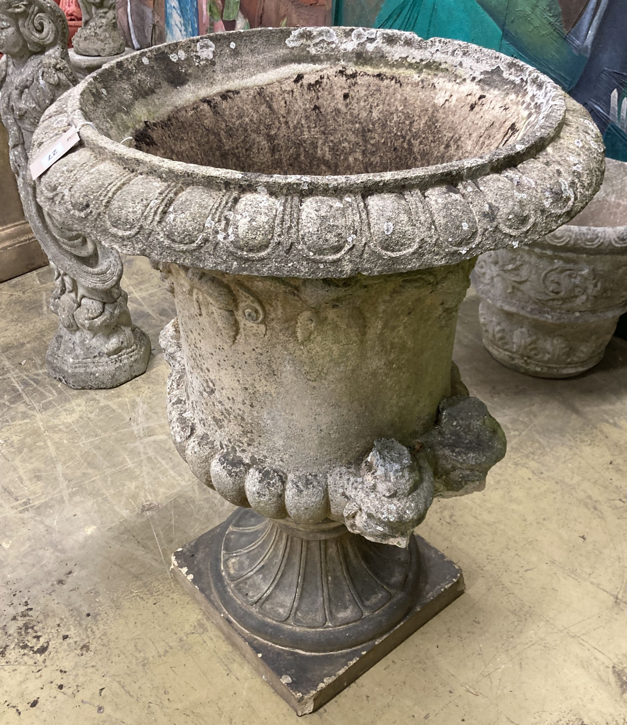 A large reconstituted stone campana garden urn, handles in need of repair, 75cm diameter, height 96cm
